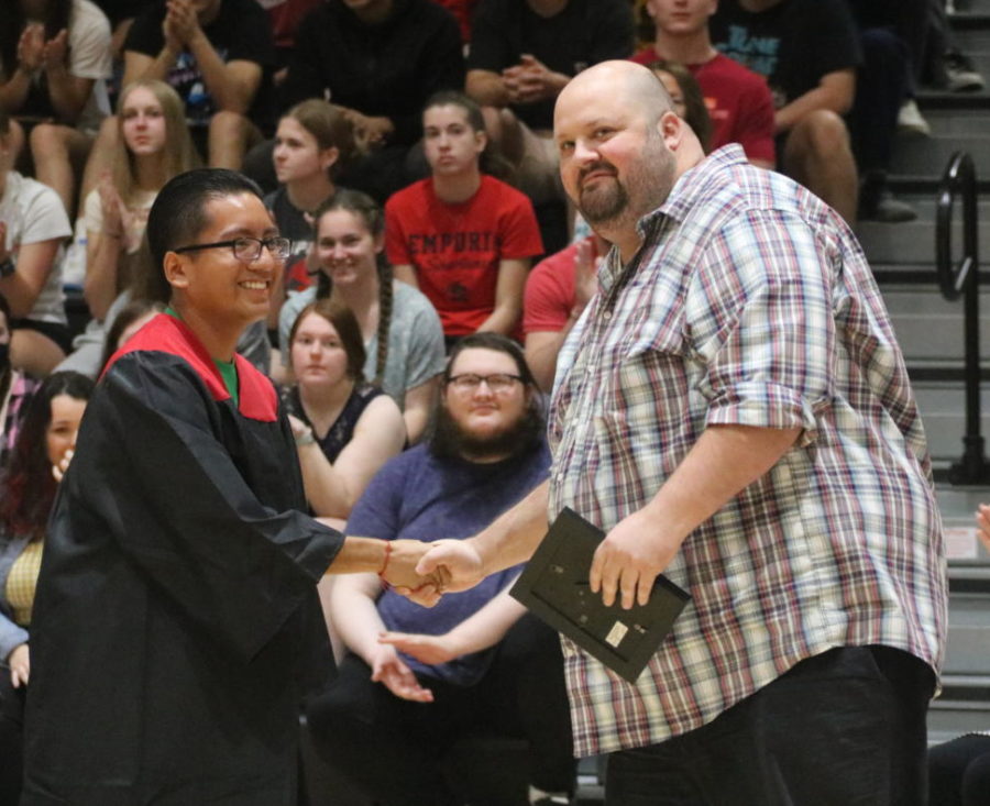During the assembly on May 10, Gilberto Aguilera (12) presents Matt Irby (science) with the award for 2022 Teacher of the Year. 