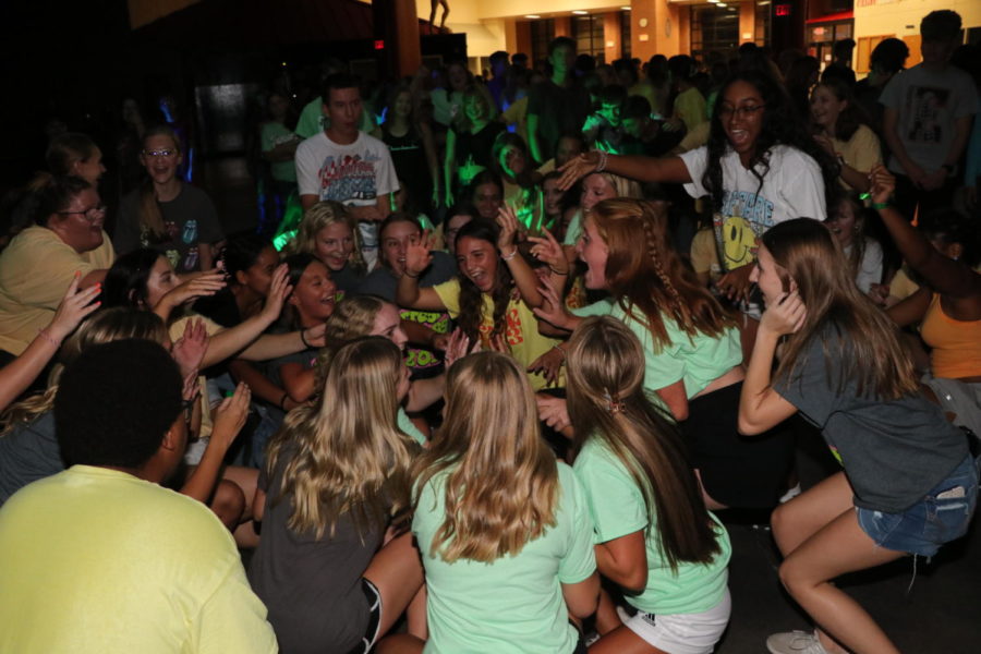 EHS students huddle in the middle of the commons during a song at the Back to School Dance. photo by laura schwinn
