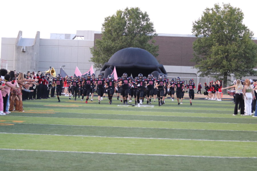 EHS Football Team runs out onto the field at the homecoming game vs Manhattan. Photo by Shaylee Ginter.