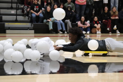 Jaylen King (12) makes an attempt at collecting balloons during a game of capture the snowball. Photo by Laney Cooper.