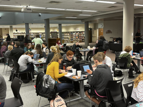 Peers sit together as they work on homework and review for upcoming finals. Photo by Laura Schwinn.